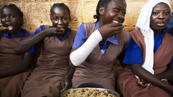 A group of students take their lunch at the Wau A Girls Primary School in Wau, South Sudan, as part of the Feeding Program run by WFP and UNICEF and funded by the European Union (EU).
