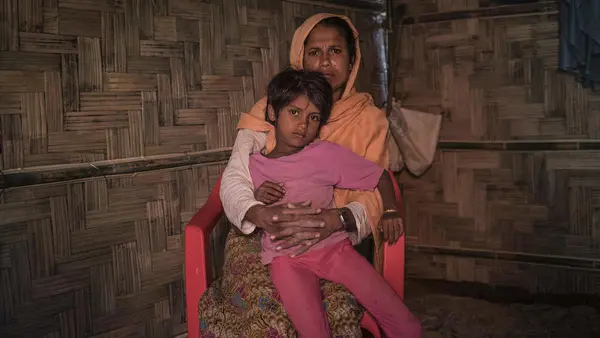 On 2 December 2019, Anjuma Bengum, 30, holds her daughter Lala Bibi, 5, at their home in Balukhali refugee camp in Cox’s Bazar, Bangladesh. Anjuma’s second daughter, Asma, 9, disappeared while on her way to buy groceries in the market.