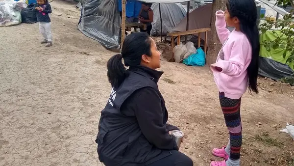 UNICEF Mexico Deputy Representative Pressia Arifin-Cabo speaks with a child at an encampment in Matamoros in the northeastern state of Tamaulipas.