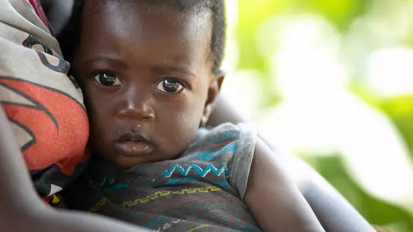 8-month-old Clinton's mother and grandmother of Tusenke, in Zambia's Gwenbe district, receive support through a UNICEF emergency cash transfer program. A prolonged drought in the country has created widespread food insecurity and other hardships.