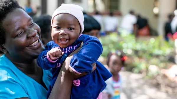 Person Holding Smiling Baby