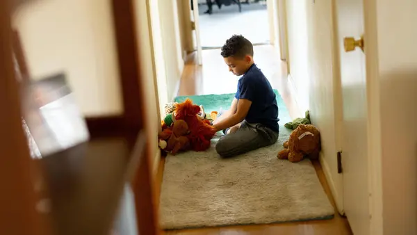 Luka, 8, plays with stuffed animals in between completing school work on his first day learning from home after his school in Connecticut closed due to the coronavirus outbreak. 