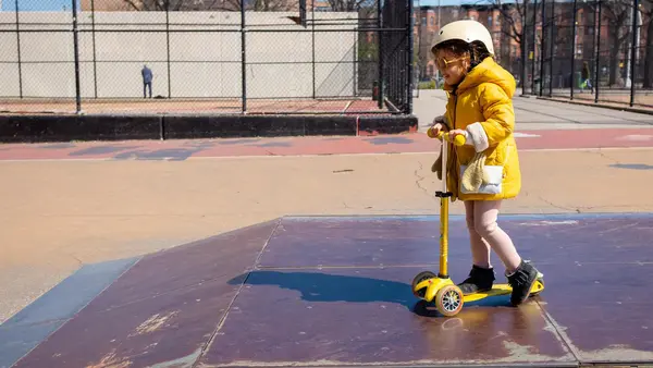 Margot, 4, rides her scooter in a park in New York City on March 26, 2020. 