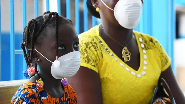 A mother and daughter wear masks during a visit to the UNICEF-supported health center outside Abidjan, in the south of Côte d'Ivoire, to protect them from COVID-19.