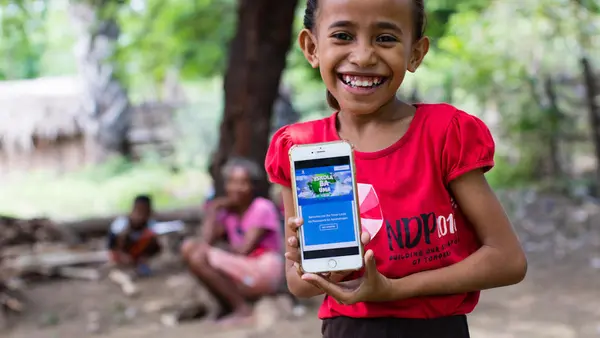 On April 14, 2020, a girl shows the online platform on which children and parents in Timor-Leste can find resources to help children continue their educations at home during the COVID-19 crisis. 