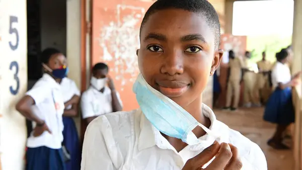 sabelle Amani, a 20 years old girl at her school in San Pedro, in the South West of Côte d'Ivoire.  Isabelle says: "I am very happy that classes resume today. I did not only missed my girlfriends enormously, but it was a waste of time and I was bored at h
