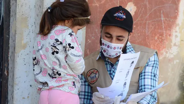 On May 14, 2020, UNICEF-supported volunteer Osama goes door-to-door providing educational activities and COVID-19 prevention information for out-of-school children in northern rural Homs, Syria.