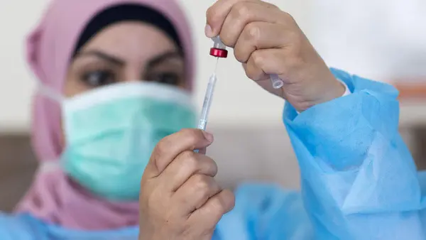 On 3 May 2020, nurse Hana Barakat prepares a vaccine at the Ministry of Health clinic in Ramallah, State of Palestine.