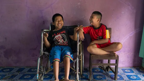 Syaiful (left), 12, a child with a physical impairment, sits next to his best friend, Kevin, 9, a child with a visual impairment, in Banyumas, Central Java, Indonesia. The boys attend a UNICEF-supported inclusive education program.