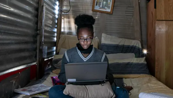 On 16 August 2020, Sebabatso Nchephe, 18, takes online classes and develops projects on her laptop, at home, a two-roomed shack she shares with her mother and two sisters in Ivory Park, an informal settlement on the outskirts of Johannesburg, South Africa