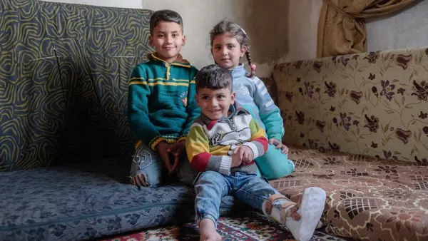 Siblings Anwar, 9, Nada, 6, and Mohammad, 3, are growing up in war-torn Syria. A UNICEF-supported cash transfer program helps their family pay for winter clothes and other necessities. 
