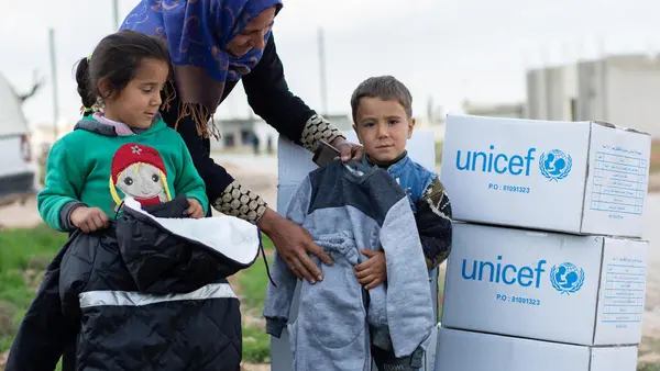 Women and Children with UNICEF Boxes