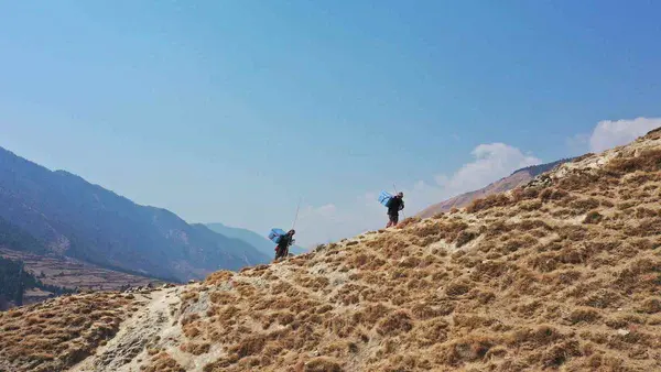 People Hiking Up a Hill