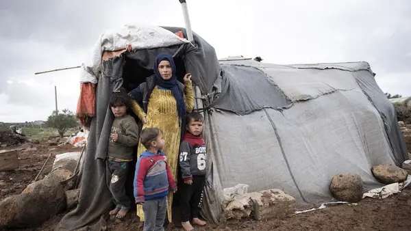 Woman with Young Children Outside Tent Entrance