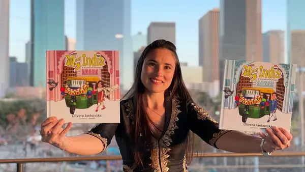Woman Holding Up Childrens Books