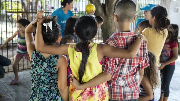 A UNICEF-supported volunteer plays with children at the St. Augustine hotel for refugees and asylum seekers in Tapachula, Mexico.