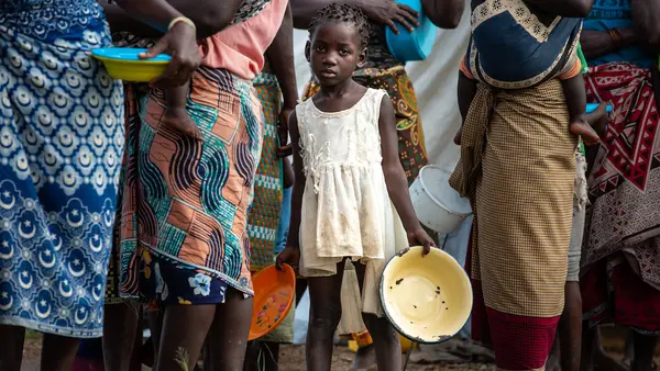 Displaced children and families queue for food at a relief distribution point outside the port city of Beira, where Cyclone Eloise made landfall on Jan. 23.