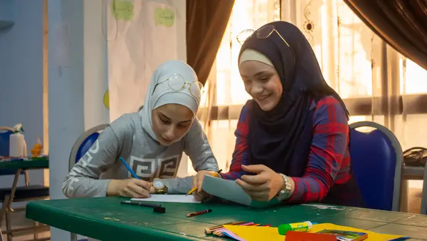 Children Drawing at a Table