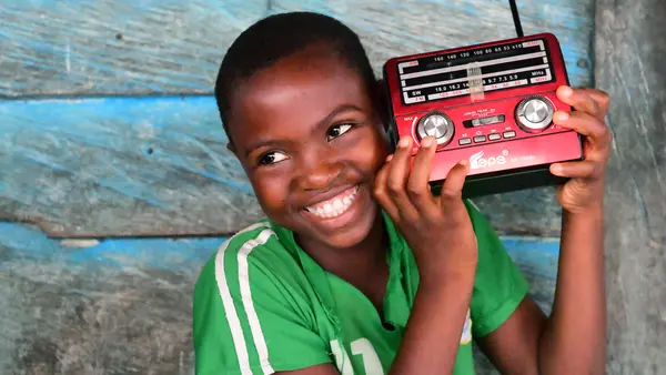 Keren, a 12 years old girl, is listening to a radio education program, in the community of Idinau, in the south west of Cameroon