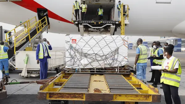 On 24 February 2021, staff unloads the first shipment of COVID-19 vaccines distributed by the COVAX Facility at the Kotoka International Airport in Accra, Ghana's capital.