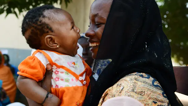 A mother with her four month old baby in Cameroon during a UNICEF nutrition activity for moms and their children.