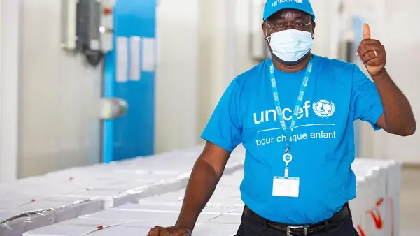 On February 26, 2021, UNICEF vaccine specialist Dr. Epa Kouacou celebrates the arrival of a shipment of COVAX COVID-19 vaccine doses in Abidjan, Côte d'Ivoire. 