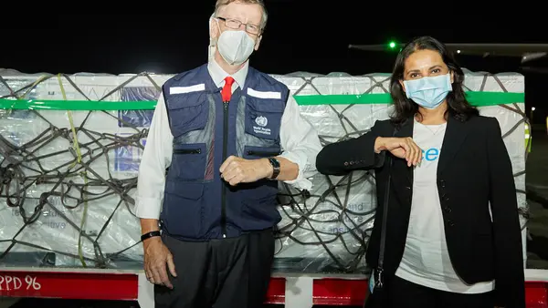 On March 3, 2021, WHO Kenya Representative Rudi Eggers (left) and UNICEF Kenya Representative Maniza Zaman receive the country's first COVID-19 vaccines from the COVAX facility at Jomo Kenyatta International Airport in Nairobi.