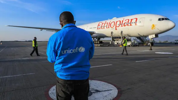 Man in UNICEF Jacket in Front of Ethiopian Airplane