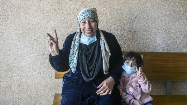 Woman and Child Holding Up Peace Signs