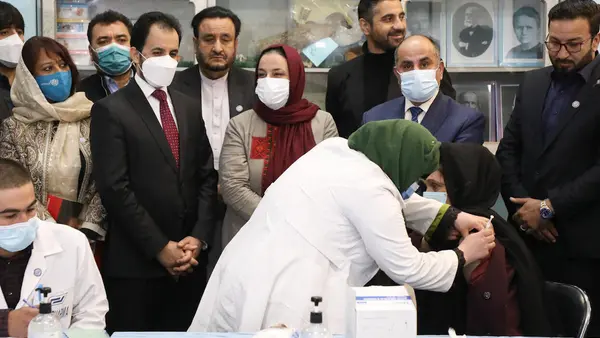 Ms. Palwasha Rafi Najemi, 40, principal of the Khwajah Rawash Girls High School receives the COVAX-facilitated COVID-19 vaccine at the Al-Fateh girls’ high school in Kabul, Afghanistan. 