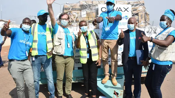 UNICEF staff cheering at Juba International Airport after the arrival of the first batch of COVID-19 vaccines in South Sudan via the COVAX Facility. 