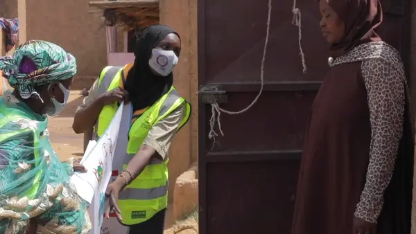 UNICEF Scout goes door to door to encourage people to get vaccinated for COVID-19 in Naimey, Niger.