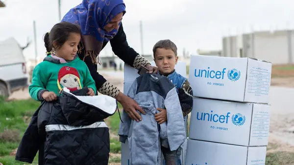 Women and Children with UNICEF Boxes