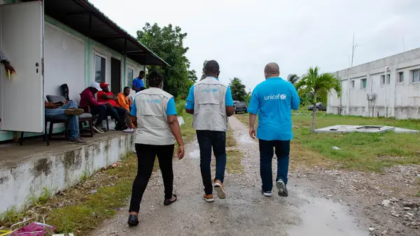 UNICEF representatives walk through the courtyard of Ofatma Hospital in Les Cayes, Haiti, on 17 August 2021. UNICEF installed tents in the courtyard shelter patients and their families who feared the hospital building could collapse.