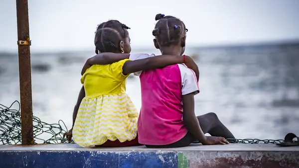 Two Girls with Arms Around Eachother