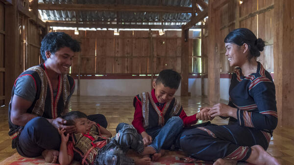 On 25 February 2020, Xu, 27, and his wife Del, 25, play with their two sons, Khon, 1, and Muih, 7, inside their home in Gia Lai, in the Central Highlands region of Viet Nam.