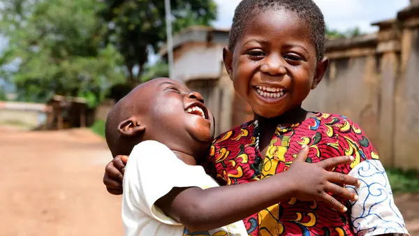 Two friends share a laugh in Korhogo, in the North of Côte d’Ivoire.