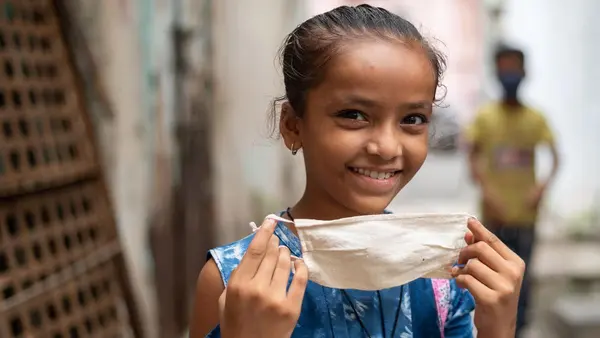 Child Putting on Face Mask