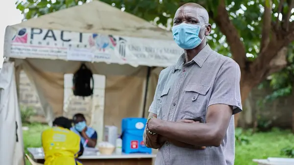 Man with Arms Folded Wearing COVID Mask