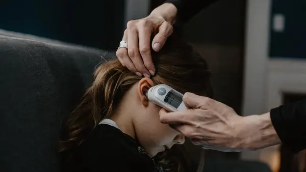 Girl Getting Temperature Taken