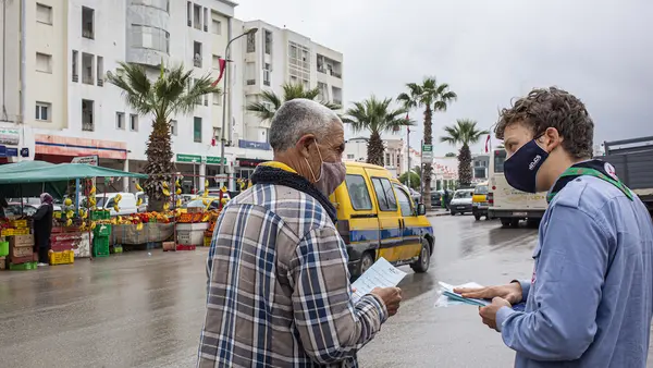 In Mhamdia, in the suburbs of Tunis, Tunisia, a group of UNICEF-trained Scouts talk to pedestrians about the risks of COVID-19 and share information about how to prevent infection. 