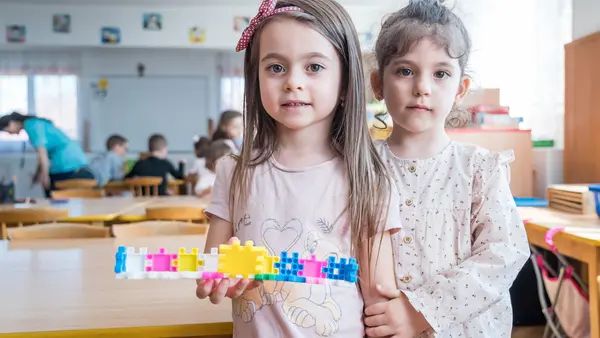 Two kindergarteners worked together to build something beautiful at their school in Brasov, Romania. 
