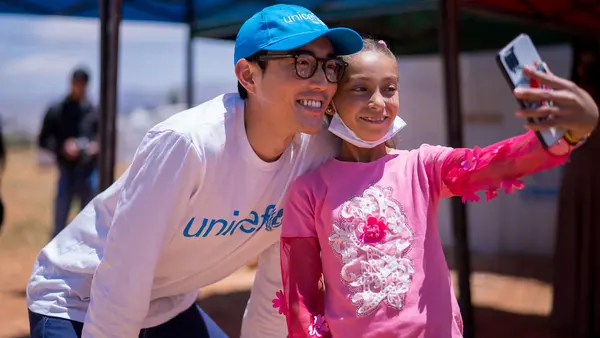 UNICEF's newest Ambassador, actor Justin H. Min (The Umbrella Academy, After Yang), poses for a selfie with 12-year-old Rasha, a refugee from Syria, in Baalbek, Lebanon on May 24, 2022. 