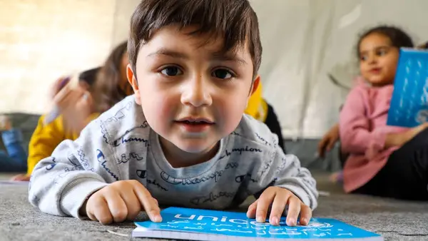 Child Reading a UNICEF Book
