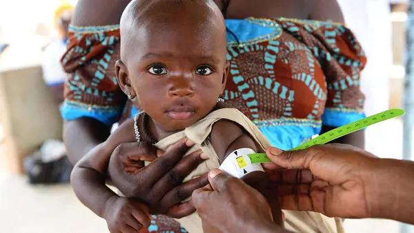 A mother with her baby at a UNICEF-supported health center in Fada, in eastern Burkina Faso where children are screened for malnutrition and vaccinated.