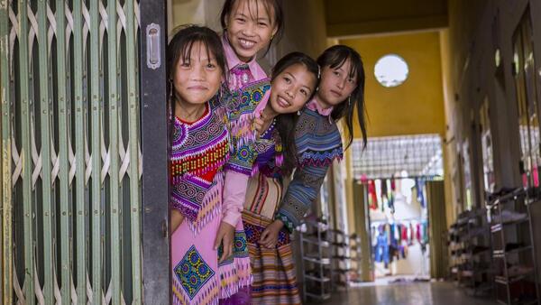A group of Grade 7 students gather in the entryway to UNICEF-supported Sin Cheng secondary school in Vietnam.