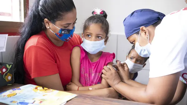 Sabrielys, 6, is vaccinated during a UNICEF-supported immunization campaign in San Vicente community, Miranda state, Venezuela.