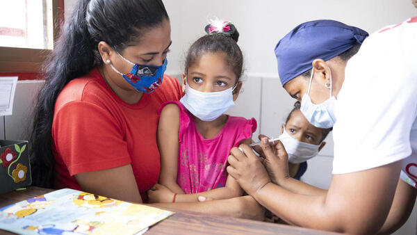 Sabrielys, 6, is vaccinated during a UNICEF-supported immunization campaign in San Vicente community, Miranda state, Venezuela.