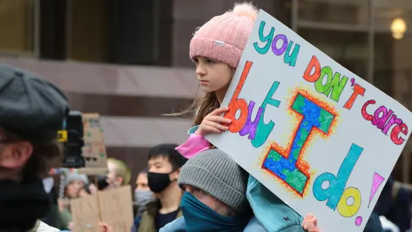 A young girl holds a sign at a Fridays for Future demonstration for climate action in Glasgow, Scotland on Nov. 5, 2021.