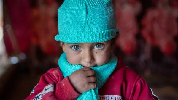 UNICEF winter clothes protect Syrian kids from the cold, like this little girl who lives in a tent.